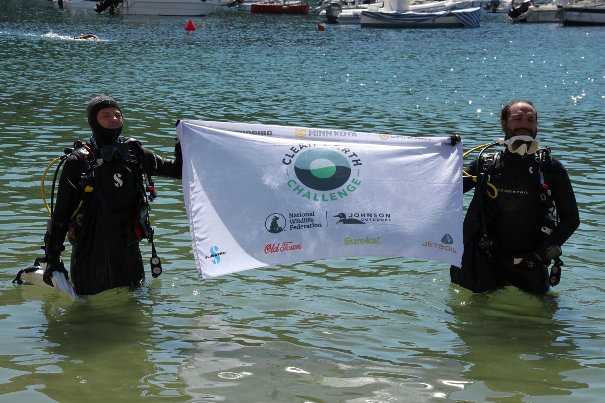 Two SCUBA Divers holding Clean Earth Challenge Flag