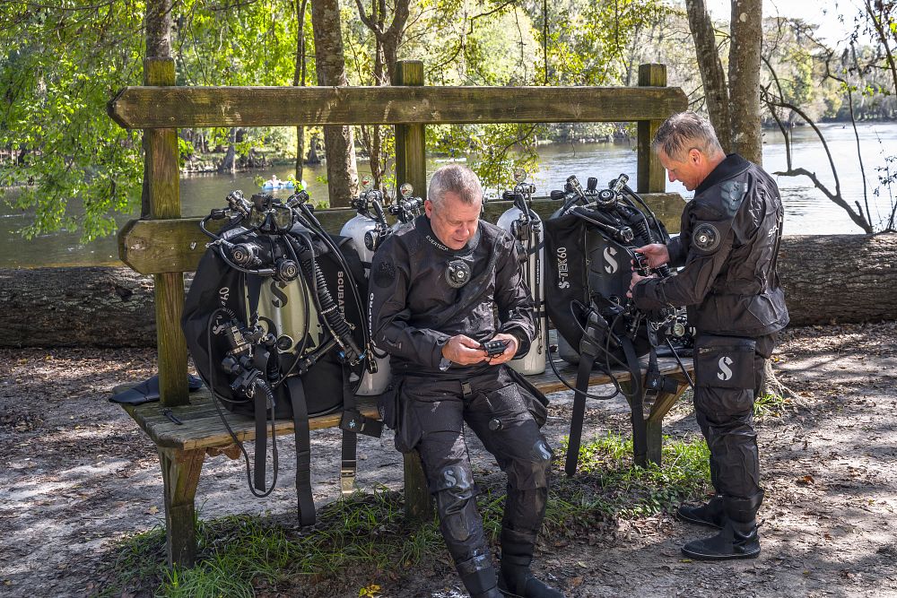 SCUBA divers looking at their gauges