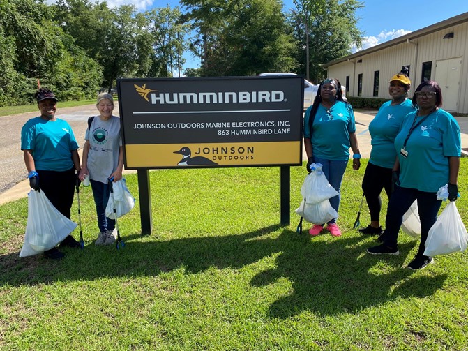 Humminbird Team Posing by Sign