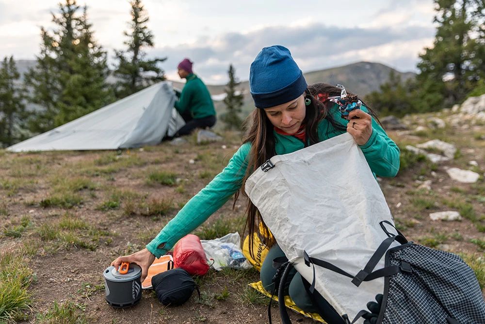Girl packing camping gear